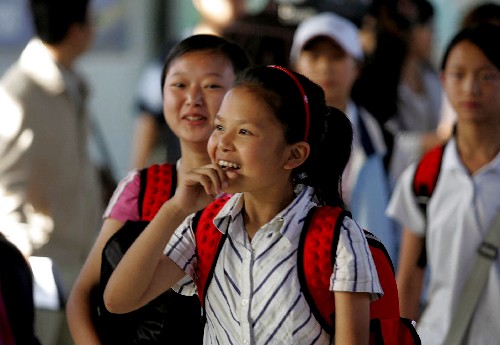 A girl from the quake-stricken Sichuan Province smiles as she arrives at a railway station in the northern Chinese city of Tianjin on Friday, May 30, 2008. She will start a new life in a middle school in the coastal city.