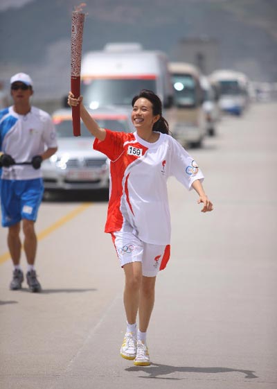 Photo: Torchbearer Karen Mok runs with the torch 