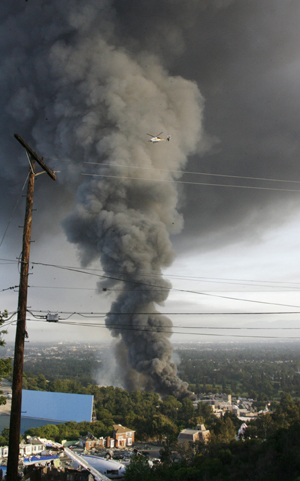 Smoke climbs hundreds of feet into the air as a fire rages out of control at the backlot filled with movie sets at Universal Studios in Universal City, California,12 miles from downtown Los Angeles June 1, 2008. 