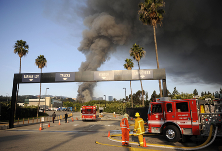 Firefighters work to contain a three-alarm fire at Universal Studios in Los Angeles June 1, 2008. Hundreds of firefighters are battling a large blaze that broke out on Sunday on a back lot at Universal Studios, site of movie and television production, a spokesman for a neighboring fire department said. 