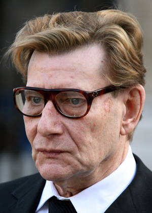 French fashion designer Yves Saint Laurent walks outside the Sainte Clothilde Church after funeral services for Lugi d'Urso, the late husband of French designer Ines de la Fressange, in Paris in this March 27, 2006 file photograph. French fashion king Yves Saint Laurent died at the age of 71 in his Paris home on Sunday evening after suffering months of declining health. 