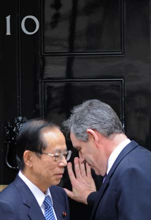 Britain's Prime Minister Gordon Brown (R) enters 10 Downing Street with his Japanese counterpart Yasuo Fukuda in London June 2, 2008. 