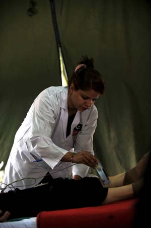 A member of the Pakistani medical team does medical checkup for a quake victim in the Wudu District of Longnan City, northwest China's Gansu Province, June 2, 2008. The 28-member Pakistani medical team has set up a tent hospital in quake-hit Longnan after it arrived in the city on May 29. 