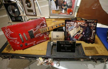 A guitar made by Bo Diddley and given to Dick Clark is displayed with other items in Dick Clark's music memorabilia collection in New York City October 25, 2006.