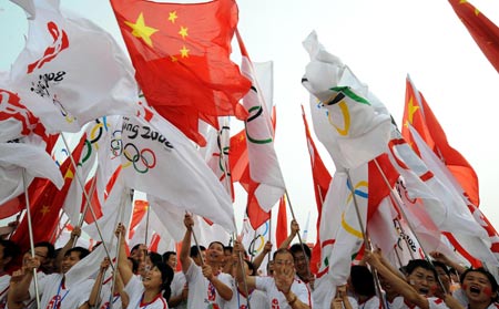 People wave flags to celebrate the 2008 Beijing Olympic Games torch relay in Xiangtan, known as the hometown of Mao Zedong, central China's Hunan Province, June 5, 2008.(