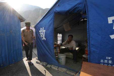 A man sprays disinfectant at the tents set in Wenchuan County, southwest China's Sichuan Province, June 8, 2008. Victims living in the epicenter town Wenchuan started to regain their normal life as a month past since the deadly earthquake struck southwest China's Sichuan Province. 