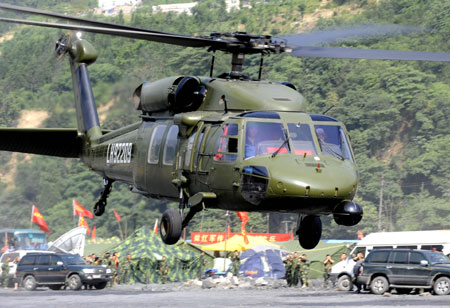  A military helicopter takes off for the spot where remains of the missing Chinese helicopter were found at Yingxiu Township, Wenchuan County in Southwest China's Sichuan Province on June 10, 2008. 