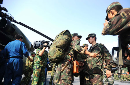 Soldiers are about to set off to the spot where remains of the missing Chinese helicopter were found at Yingxiu Township, Wenchuan County in Southwest China's Sichuan Province on June 10, 2008.