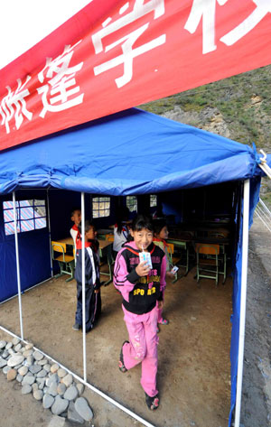 Children walk into a tent school in Shidaguan Township of Maoxian County, southwest China's Sichuan Province, June 10.