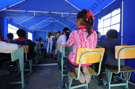 Children attend class in a tent school in Shidaguan Township of Maoxian County, southwest China's Sichuan Province, June 10. 
