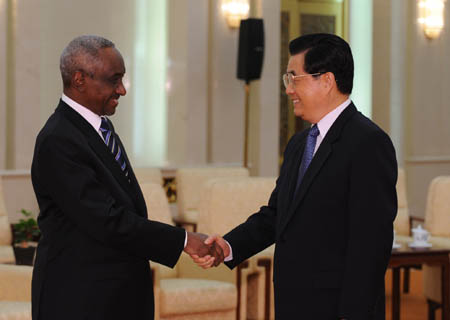 Chinese President Hu Jintao (R) shakes hands with Sudanese Vice President Ali Osman Mohammed Taha, in Beijing, capital of China, June 11, 2008. 
