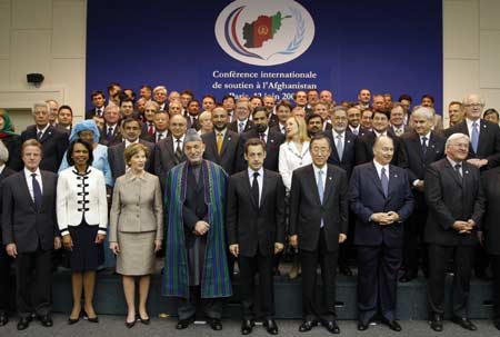 France's President Nicolas Sarkozy (C) poses between U.N. Secretary-General Ban Ki-moon (R) and Afghanistan's President Hamid Karzai (L) at the start of the international conference in support of Afghanistan at Kleber International Centre in Paris June 12, 2008. Standing with them (front row, L-R) are: France's Foreign Minister Bernard Kouchner, U.S. Secretary of State Condoleezza Rice, U.S. first lady Laura Bush, Aga Khan and German's Foreign Minister Frank-Walter Steinmeier. Ministers from dozens of countries gathered in Paris to pledge funds for Afghanistan and review their development strategy for the violence-plagued state. 