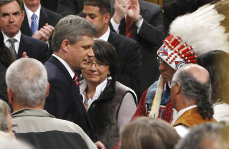 Canada's Prime Minister Stephen Harper speaks to Assembly of First Nations National Chief Phil Fontaine after issuing an apology in the House of Commons on Parliament Hill in Ottawa June 11, 2008. Canada, seeking to close one of the darkest chapters in its history, formally apologized on Wednesday for forcing 150,000 aboriginal children into grim residential schools, where many say they were abused. 