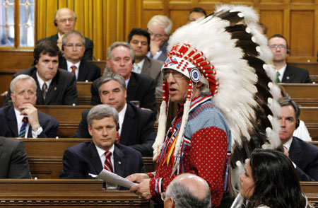 Canada's Prime Minister Stephen Harper (bottom L) and other MP's listen as National Chief of the Assembly of First Nations Phil Fontaine (R) speaks in the House of Commons on Parliament Hill in Ottawa June 11, 2008. 