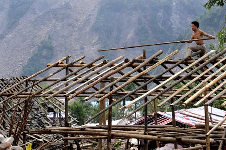 A local man builds house at ruins at Yuzixi Village, Yingxiu Township, Wenchuan County in Southwest China's Sichuan Province, June 9, 2008. Residents in quake-hit Yingxiu Township are now reconstructing their hometown. 
