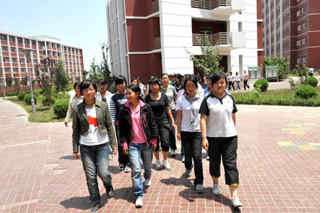 High school students from quake-affected Qingchuan of southwest China's Sichuan Province go to the dining-room after they arrive at Liupanshan Higher Middle School in Yinchuan, capital of northwest China's Ningxia Hui Autonomous Region, on June 12, 2008. A total of 130 high shool students from Qingchuan will continue their studies at Ningxia Liupanshan Higher Middle School. Their school tuitions and daily costs are covered by the government of Ningxia Hui Autonomous Region.