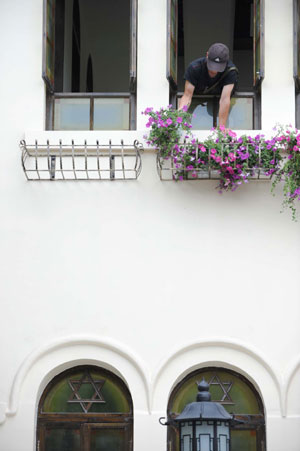 A worker decorates a French style house at a historical culture preservation district in Chengdu, capital of southwest China's Sichuan Province, June 13, 2008. 