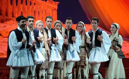 Performers from the Greek troupe Dora Strotou play the folk dance during the China Xinjiang International Folk Dance Festival in Urumqi, capital of northwest China's Xinjiang Uygur Autonomous Region, June 14, 2008.