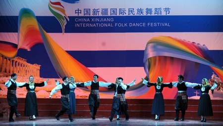 Performers from the Greek troupe Dora Strotou play the folk dance during the China Xinjiang International Folk Dance Festival in Urumqi, capital of northwest China's Xinjiang Uygur Autonomous Region, June 14, 2008. 