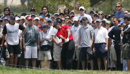 Tiger Woods hits from the rough on the first hole during the fourth round of the U.S. Open golf championship at Torrey Pines in San Diego June 15, 2008. 