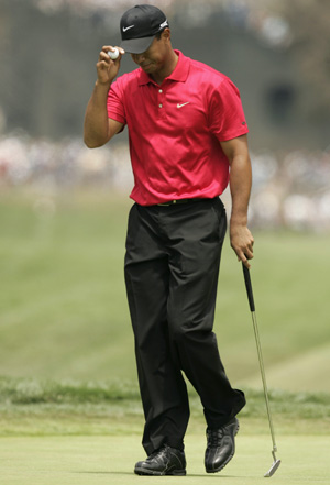 Tiger Woods walks off the first hole after a double bogey during the fourth round of the U.S. Open golf championship at Torrey Pines in San Diego June 15, 2008. 