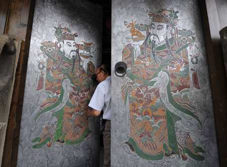 A tourist enters a shop at a historical culture preservation district in Chengdu, capital of southwest China's Sichuan Province, June 13, 2008. 