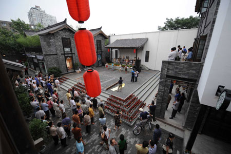 People watch the rehearsal of traditional performances at a historical culture preservation zone in Chengdu, capital of southwest China's Sichuan Province, June 13, 2008.
