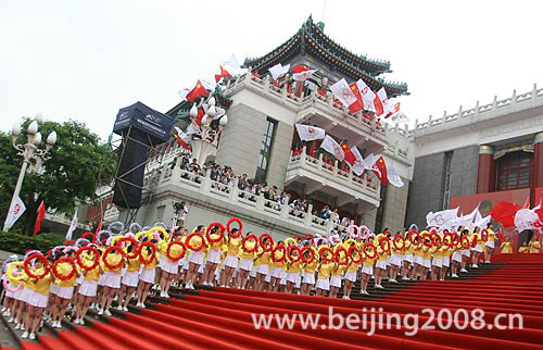 Photo: Local people celebrate the arrival of the Olympic torch at Great Hall of the People