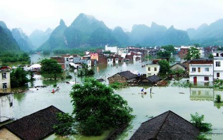 People use bamboo rafts to get about yesterday in the town of Longtou in the Guangxi Zhuang autonomous region. [Photo: Xinhua] 