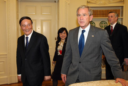 U.S. President George W. Bush (R) meets with Chinese Vice Premier Wang Qishan in the White House, June 18, 2008. Bush applauded the results of the fourth Sino-U.S. Strategic Economic Dialogue (SED) that concluded earlier in the day. 