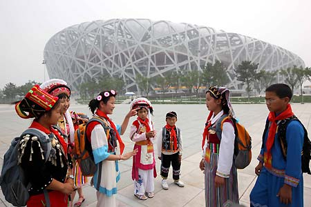 Several boys and girls from China's ethnic minorities, most deaf, communicate with each other using sign language in front of the National Stadium, or 'Bird's Nest', June 19, 2008. As members of the 56 ambassadors of China's 56 ethnic groups, these children will enjoy the host city in a five-day 'Olympic Tour' event until June 23.