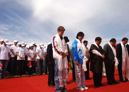 Participants stand for one minute in silence to mourn the victims affected by last month&apos;s earthquake at an opening ceremony during the Beijing Olympic torch relay along Qinghai Lake, the largest inland saltwater lake in China, June 23, 2008. Half of the 162 torchbearers are Tibetans.