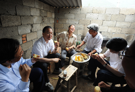 Chinese Premier Wen Jiabao (2nd L) eats potato with local residents at Douping Village in Kangxian County, northwest China's Gansu Province, June 21, 2008. 