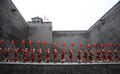 Dancers rehearsal on the ancient city walls of Pingyao in North China's Shanxi Province June 22, 2008. The Olympic flame will arrive at Pingyao on Wednesday.