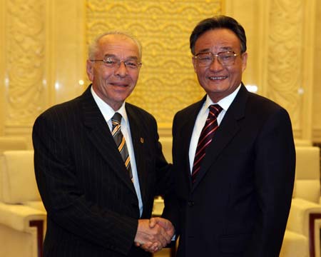 Wu Bangguo (R), China's National People's Congress (NPC) Standing Committee chairman, shakes hands with visiting Romanian Senate president Nicolae Vacaroiu at the Great Hall of the People in Beijing, capital of China, June 23, 2008.