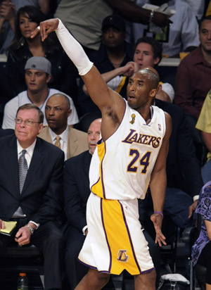 Los Angeles Lakers Kobe Bryant follows through on a three-point shot in the first quarter against the Boston Celtics during Game 5 of the NBA Finals basketball championship in Los Angeles, June 15, 2008. 