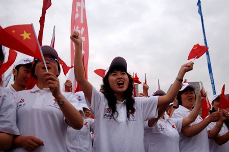 People cheer for the 2008 Beijing Olympic Games torch relay in Xining, northwest China's Qinghai Province, on June 24, 2008.