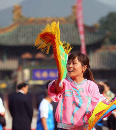 Local residents perform a folk dance during the Beijing Olympic torch relay in Taiyuan, Shanxi Province, June 26, 2008.