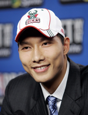 Yi Jianlian of China smiles as he wears a Milwaukee Bucks cap after being selected by the Bucks as the sixth overall pick at the 2007 NBA Draft at Madison Square Garden in New York June 28, 2007. 