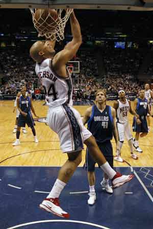 New Jersey Nets forward Richard Jefferson makes a reverse stuff shot in front of Dallas Mavericks forward Dirk Nowitzki (41) in the fourth quarter of their NBA basketball game in East Rutherford, New Jersey, Feb. 10, 2008.(Xinhua/Reuters, File Photo)