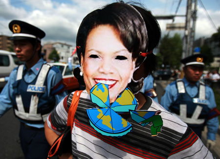 An anti-G8 protester wears a paper mask of U.S. Secretary of State Condoleezza Rice during a rally in Kyoto, western Japan, on June 26, 2008, prior to the two-day G8 Foreign Ministers' Meeting to be held in the city from June 26 to 27.(