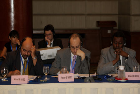 Attendees are present at a conference under the theme of 