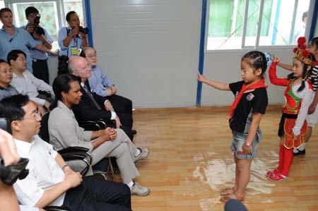 U.S. Secretary of State Condoleezza Rice (2nd L, Front) watches the performance of local children at a resettlement in Dujiangyan City, southwest China's Sichuan Province, June 29, 2008. Arriving in Dujiangyan City on Sunday, Rice visited survivors at a resettlement and extended condolences for the survivors in the quake-hit region. 