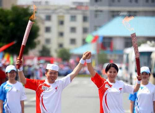 Photo: Torchbearers hold the torches