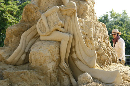 An artist makes the final touches on a sand sculpture before the official opening of the First international sand sculptures festival in the Black Sea costal town of Bourgas, some 390 km (246 miles) east from capital Sofia, June 30, 2008. 