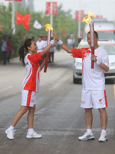 Photo: Torchbearers hold their hands together