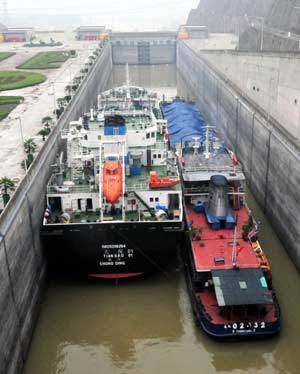 The flotilla of a super marine oil tanker of Tianbao 01 sails through the dual-passage and five-step navigation lock of the Three Gorges Project in Yichang City, central China's Hubei Province, July 1, 2008.