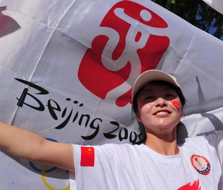 A girl cheers for the 2008 Beijing Olympic Games torch relay in Dunhuang, a city of northwest China&apos;s Gansu Province, on July 5, 2008. 