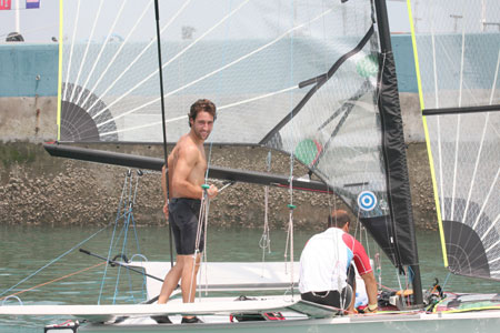 Two foreign athletes practise for the Olympic sailing competition in Qingdao, Shandong Province July 6, 2008. With algae almost cleared, Olympic sailors begin to practise normally.