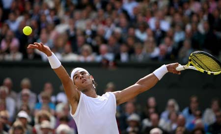 Rafael Nadal of Spain serves against Roger Federer of Switzerland during the men's singles final match at the Wimbledon tennis tournament in London, capital of Britain, on July 6, 2008. Spain's Rafael Nadal won the match 6-4, 6-4, 6-7, 6-7, 9-7 and claimed the title.